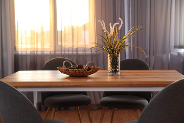 Wall Mural - Vase on wooden table near window with curtains in room