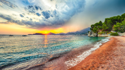 Wall Mural - Fantastic sunset view of Adriatic coast at Sveti Stefan beach  near Budva.