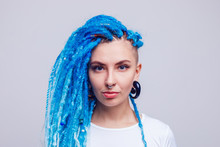 Portrait Of A Woman With Blue Dreadlocks And A Piercing. Informal Young Woman.