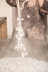 Wall Mural - boiling silkworm cocoons to produce silk rope