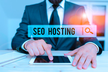 Poster - Conceptual hand writing showing Seo Hosting. Concept meaning building website in a way that is friendly for search engines Male human wear formal clothes present use hitech smartphone
