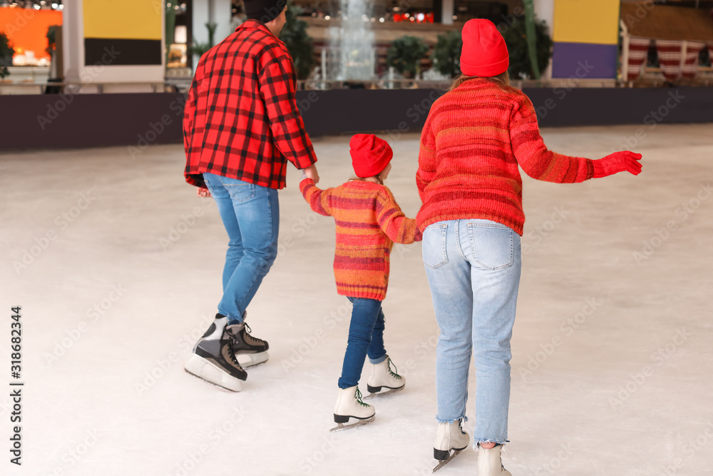 Young family on skating rink