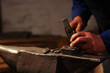 © Filip - Blacksmith hands hitting with hammer on a anvil using iron,steel, mettal molds