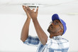 locksmith examines the fan on ceiling