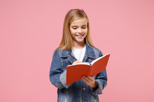 Smiling Little Blonde Kid Girl 12-13 Years Old Wearing Denim Jacket Isolated On Pastel Pink Background Children Portrait. Childhood Lifestyle Concept. Mock Up Copy Space. Writing Notes In Notebook.