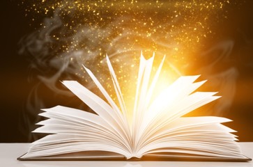 Wall Mural - open book with light fantasy illustration on table