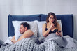 Girlfriend secretly chatting with others while he sleeps. Infidelity concept