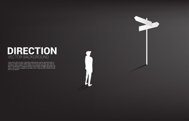 Poster - Silhouette of businessman standing at direction signage. Concept of time to make decision in business direction
