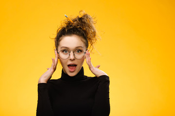 Wall Mural - Pretty teenage girl with happy face on yellow background