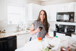 © MeganBetteridge - Lifestyle of women unloading her groceries at home in a white kitchen