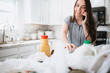 © MeganBetteridge - Lifestyle of women unloading her groceries at home in a white kitchen