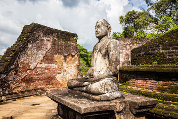 Vatadage (circular relic house) with Buddha setiing in the middle, Polonnaruwa, a Royal Palace Ruin of an Ancient City in Sri Lanka