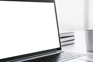 Closeup of blank laptop screen on a white table with cup of coffee, mockup. 3D Rendering