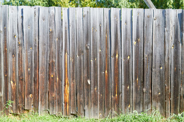 Wall Mural - Old wooden fence in summer village in Russia