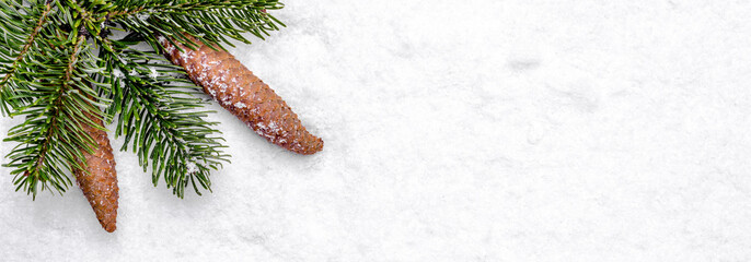 Wall Mural - Christmas white background with snow and christmas fir branch with pine cones, flat lay, top view