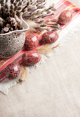 Wall Mural - Easter still life with Pysanka and willow branches in ceramic jug on traditional Ukrainian cloth. Decorated Easter eggs, traditional for Eastern Europe culture