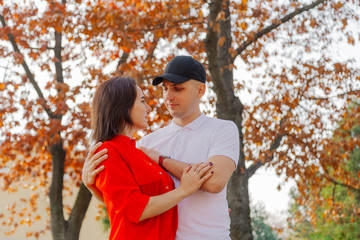 Happy couple in love on a background of yellow leaves in autumn.