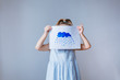 © Angelina - little girl holding a cloud drawing on a white background