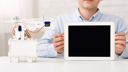 Poster - Mockup for advertisement. Boy holding tablet with blank screen