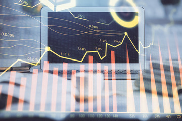 Stock market graph and table with computer background. Multi exposure. Concept of financial analysis.