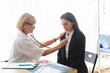 © eakgrungenerd - woman doctor using stethoscope examining patient, health and care concept.