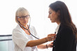 © eakgrungenerd - woman doctor using stethoscope examining patient, health and care concept.