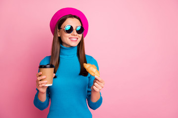 Poster - Portrait of positive girl travel trip enjoy cafe rest hold takeout mug latte beverage delicious croissant wear blue retro sunglass headwear isolated over pastel pink color background