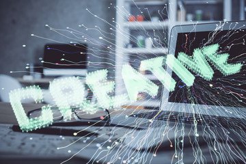 Desktop computer background in office and start up theme hologram drawing. Double exposure. Startup concept.