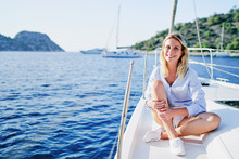 Luxury Travel On The Yacht. Young Happy Woman On Boat Deck Sailing The Sea. Yachting In Greece.