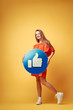 Happy beautiful young woman holding a like notification icon. People, Social media Networking, Messages and technology concept.