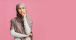 © Prostock-studio - Pensive muslim girl thinking and looking away on pink studio background