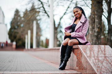 Wall Mural - Young stylish beautiful african american woman in street, wearing fashion outfit coat.