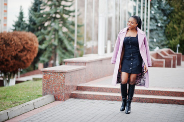 Wall Mural - Young stylish beautiful african american woman in street, wearing fashion outfit coat.