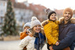 © pikselstock - Happy young family having fun outdoors during Christmas