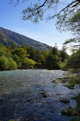  Beautiful crystal clear water river landscape with mountain background in Japan Alps Kamikochi, Nagano, Japan