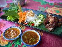 CLOSE-UP OF Pork Rib Thai Food ON TABLE At Chatuchak Weekend Market, Bangkok, Thailand