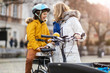 © pikselstock - Young woman and her son riding the bicycle in a city