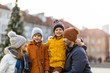 © pikselstock - Happy young family having fun outdoors during Christmas