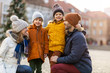 © pikselstock - Happy young family having fun outdoors during Christmas