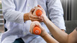 © Pichsakul - instructor assisting senior doing exercise working out in clinic strengthening muscles and developing joints.