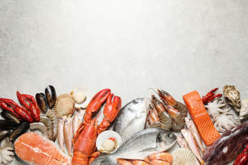 Wall Mural - Fresh fish and seafood on marble table, flat lay. Space for text