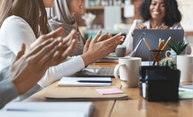 Canvas Print - Cropped of multiethnic team of employees clapping hands