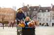© pikselstock - Young family enjoying spending time together, riding in a cargo bicycle