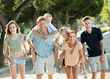 © JackF - Adult parents with kids taking fast promenade