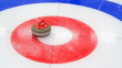 © SARATSTOCK - Curling winter, olympic sport.Curling stone and  Ice curling sheet with red and blue circle and visible pebbles