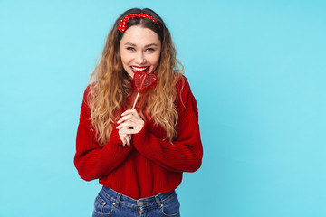 Sticker - Image of cheerful blonde woman licking candy and smiling