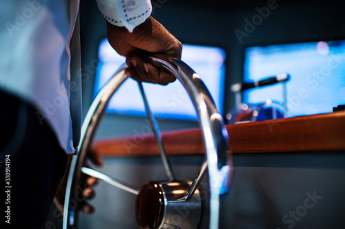 Cuadros en Lienzo Boat captain hands navigating and moving instruments in the cockpit