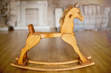 Nice Vintage Classic Wooden Rocking Horse Chair On Wooden Floor Shot In A Blurred Vintage Interior Background.