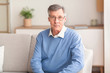 © Prostock-studio - Senior Gentleman Looking At Camera Sitting On Sofa At Home