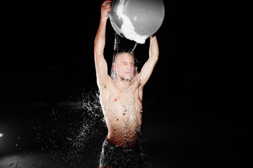 Healthy hardening. Young man dives and walks in the snow after hot sauna and bathes in cold water. Strengthening the body and spirit concept